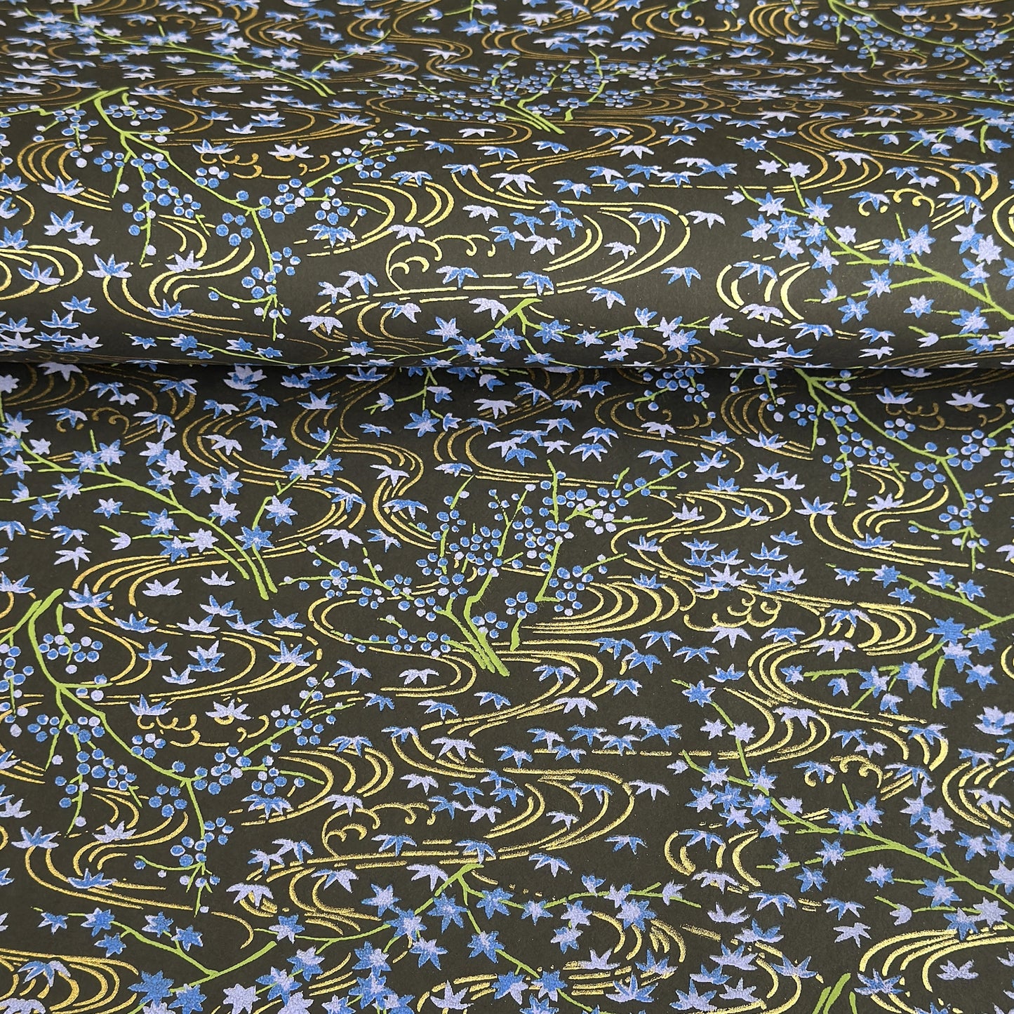 Gold rivers (kawa) with purple falling leaves (fukiyose) and foliage on a black backdrop. Japanese chiyogami paper