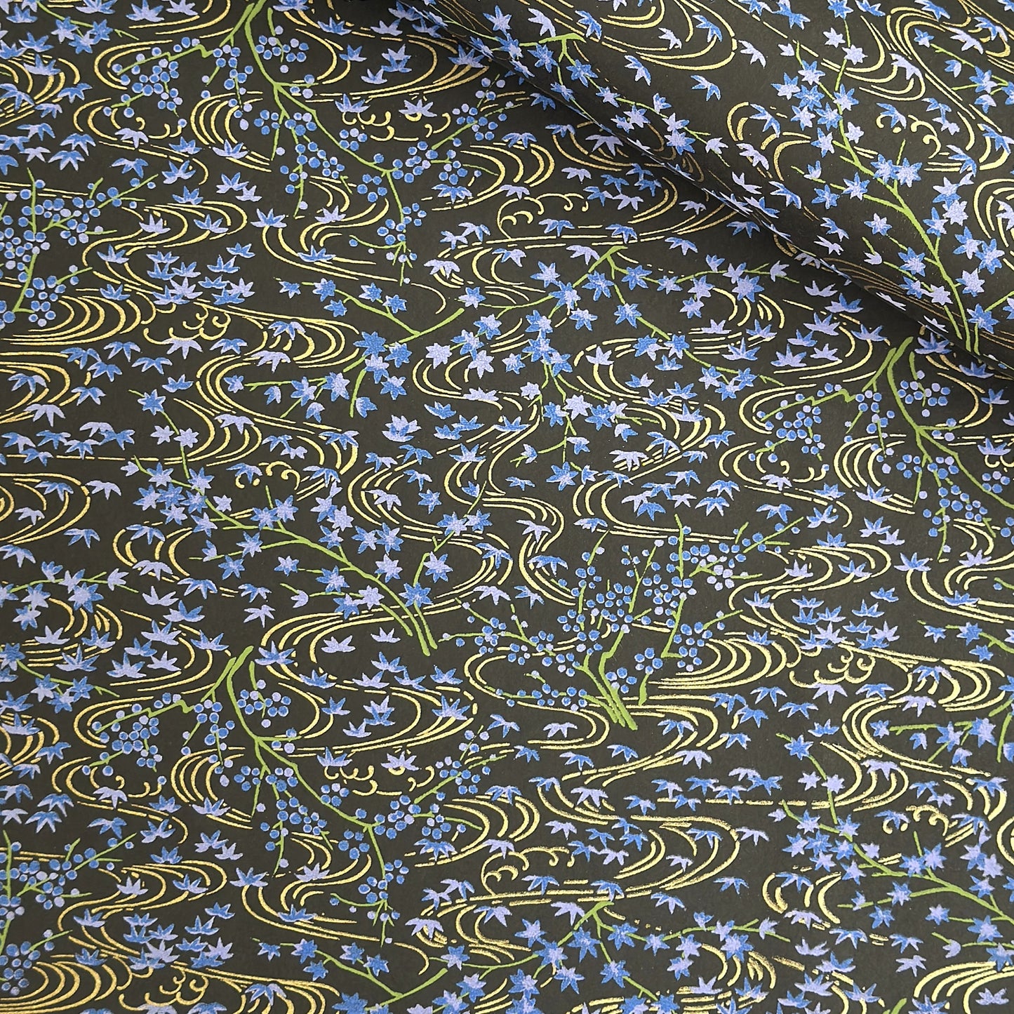 Gold rivers (kawa) with purple falling leaves (fukiyose) and foliage on a black backdrop. Japanese chiyogami paper