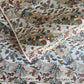 japanese silk-screen handmade paper showing taupe and pale blue waves pattern with multicolour flowers and foliage, with gold accents