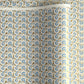 Japanese silkscreen chiyogami paper with a repeat floral pattern in gold an cerulean blue
