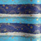 japanese chiyogami paper in stripes of blue, turquoise and grey with gold clouds and flowers