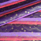 japanese chiyogami paper in stripes of pink, lilac and purple with gold clouds and flowers
