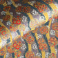Japanese silkscreen chiyogami paper with a traditional botanical circle motif in tones of mustard, inky blue, lilac and gold.