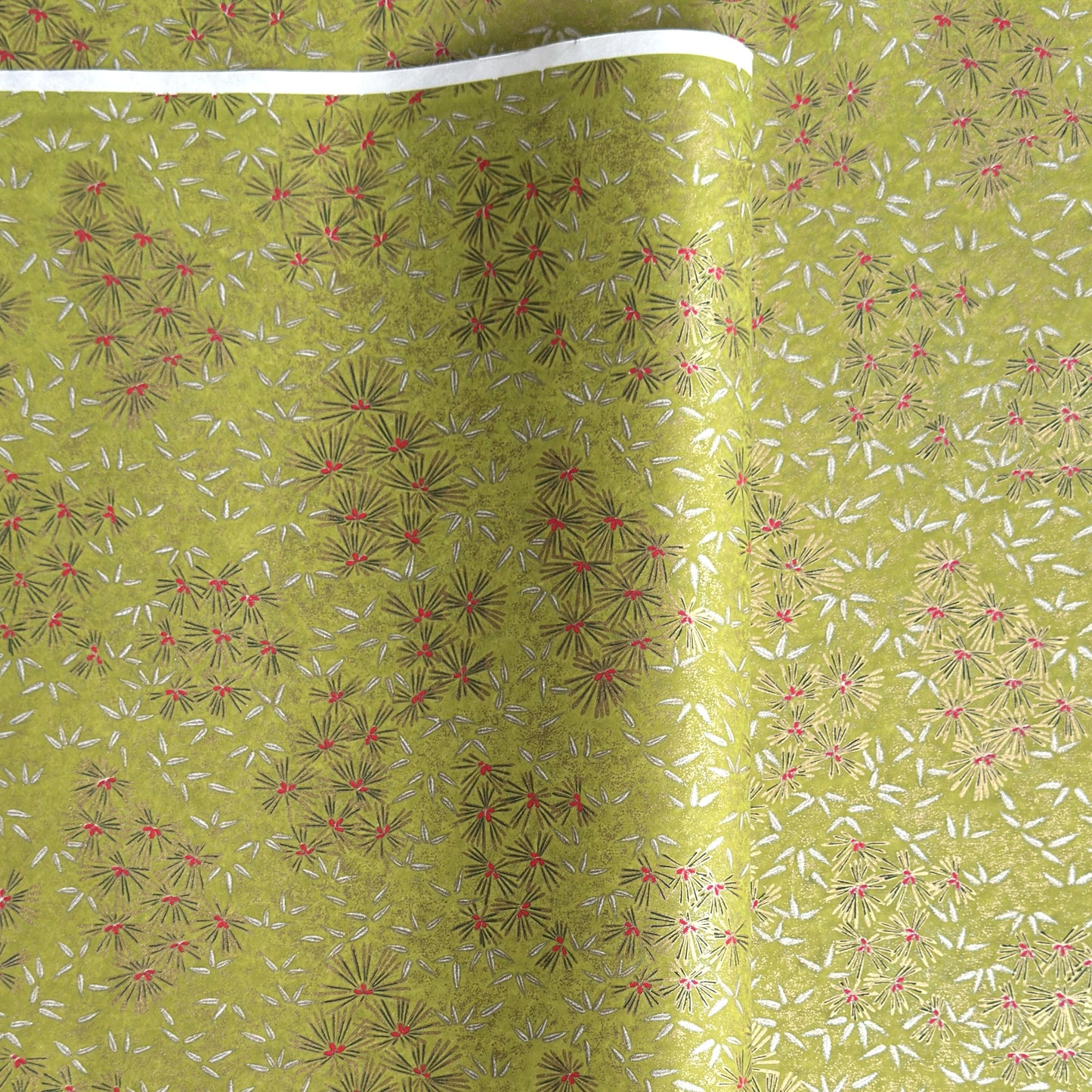 Pattern of scattered pine needles (matsuba) in gold and silver on an olive backdrop.  Japanese chiyogami paper