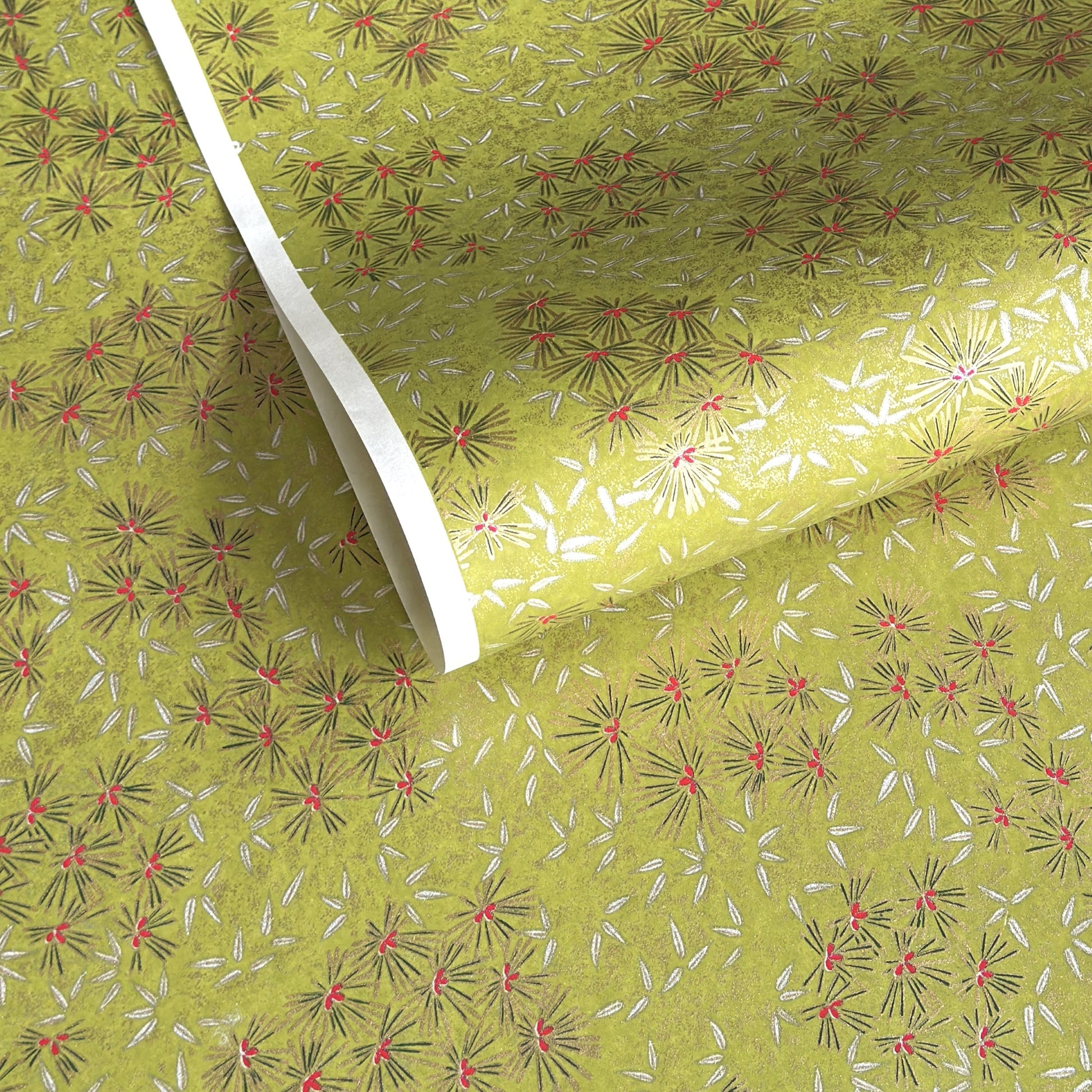 Pattern of scattered pine needles (matsuba) in gold and silver on an olive backdrop.  Japanese chiyogami paper