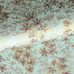 Japanese chiyogami paper silkscreen printed with gold pine needle design on a soft aqua backdrop.