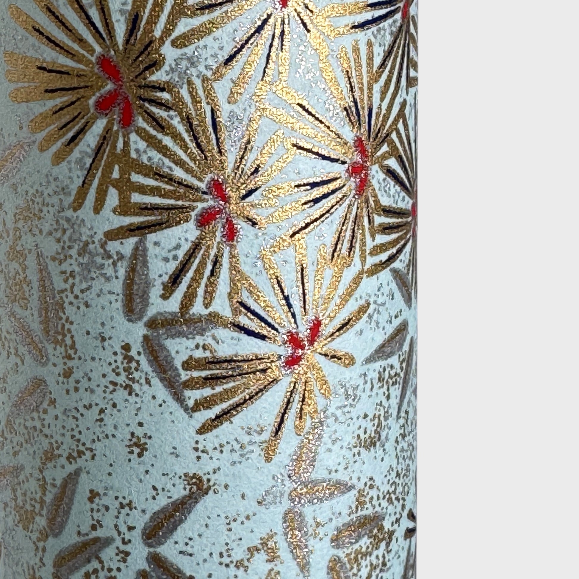 Japanese chiyogami paper silkscreen printed with gold pine needle design on a soft aqua backdrop.