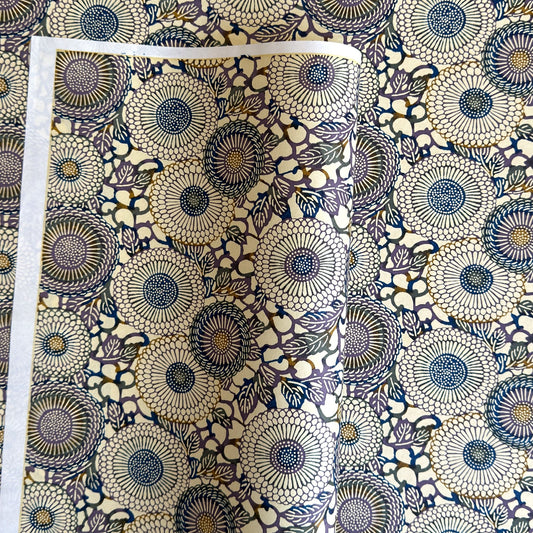 Japanese chiyogami silkscreen printed paper with a floral kiko pattern in purple and blue on a cream backdrop