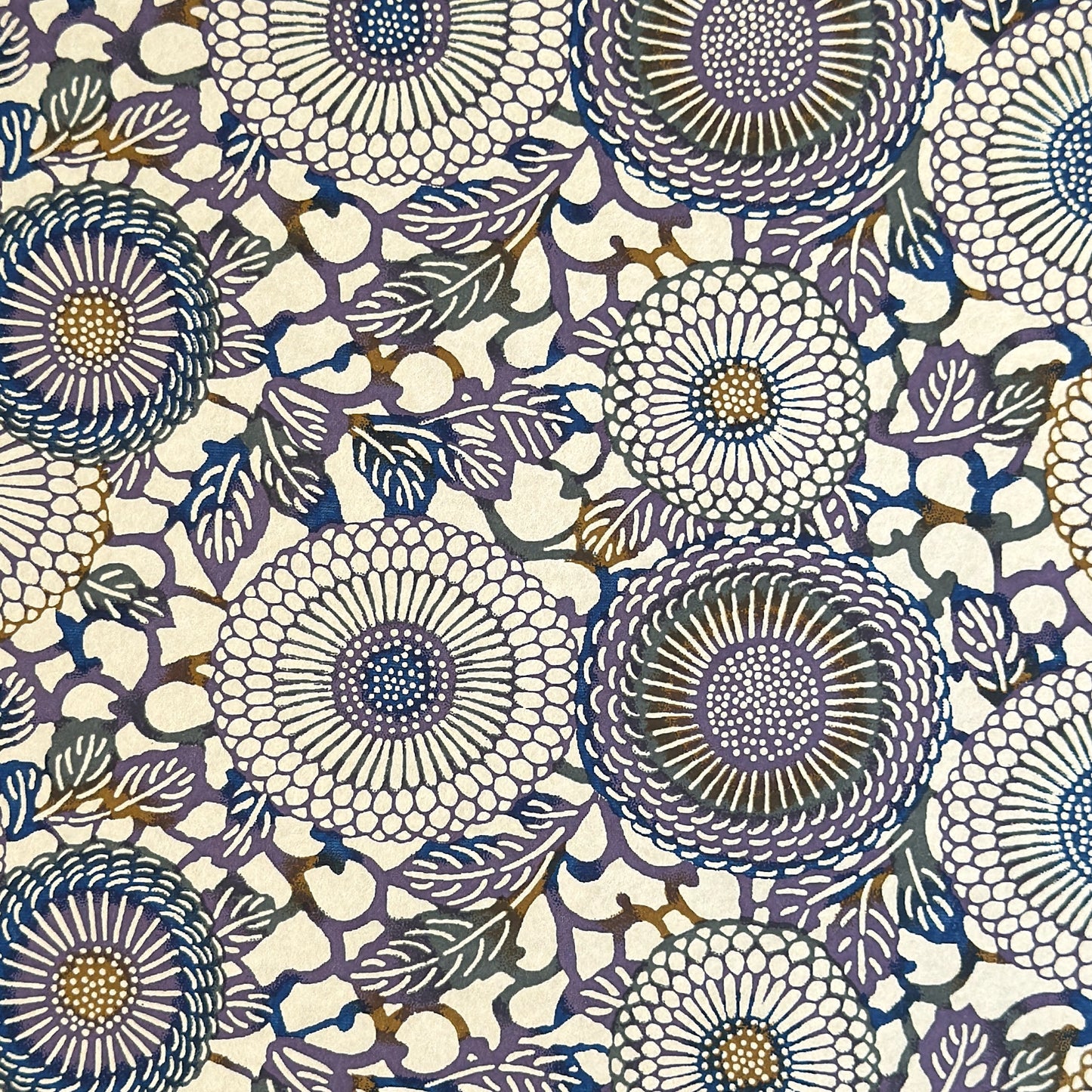 Japanese chiyogami silkscreen printed paper with a floral kiko pattern in purple and blue on a cream backdrop