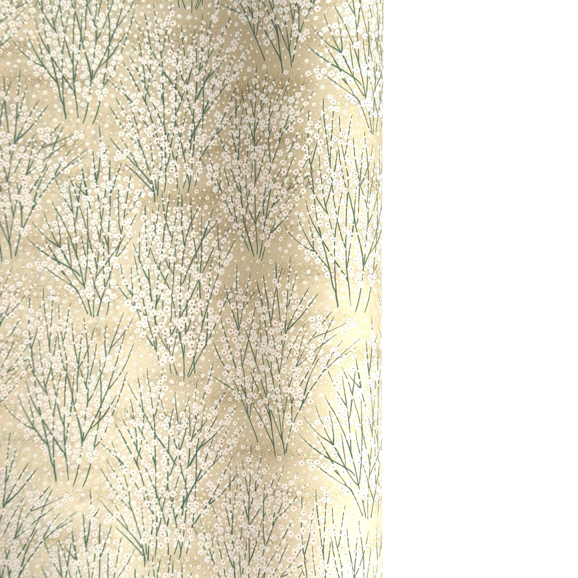 a sheet of Japanese silkscreen printed chiyogami paper with a delicate design of tufts of meadow grasses in flower in white, green on a cream background