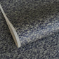 a sheet of Japanese chiyogami yuzen paper with a small abstract pattern in midnight blue on grey