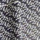 Japanese chiyogami paper with a silkscreened pattern of white cranes in flight on a midnight blue and gold background.