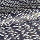 Japanese chiyogami paper with a silkscreened pattern of white cranes in flight on a midnight blue and gold background.