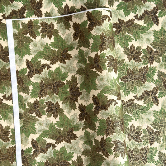 Japanese chiyogami paper with a pattern of green leaves in various tones with gold accent.