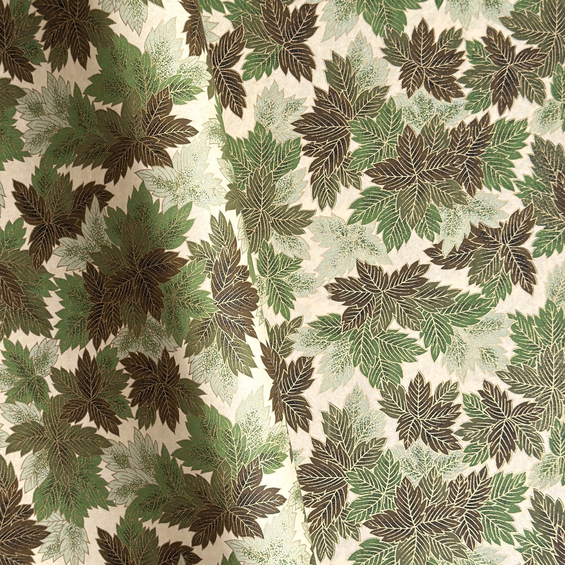 Japanese chiyogami paper with a pattern of green leaves in various tones with gold accent.