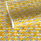 japanese silk-screen handmade paper showing circles of traditional motifs on yellow backdrop