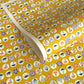 japanese silk-screen handmade paper showing circles of traditional motifs on yellow backdrop