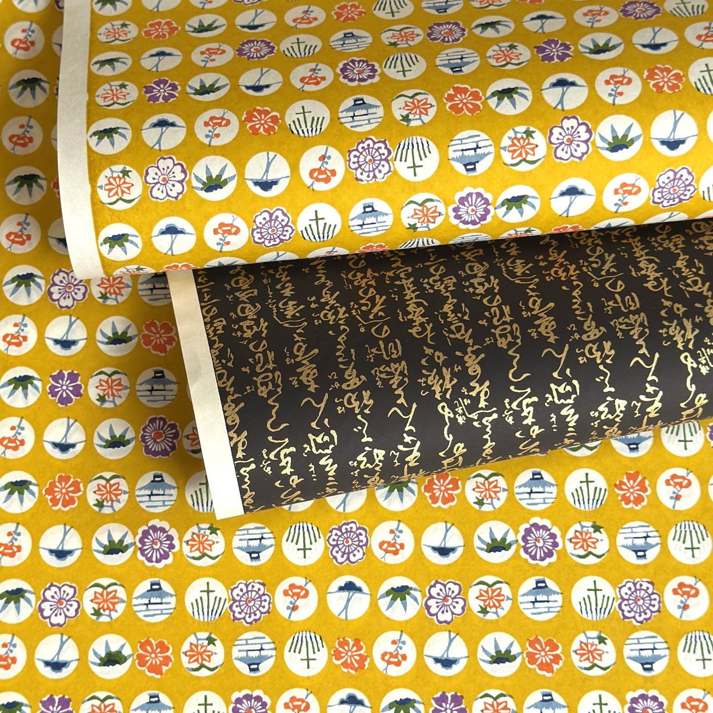 japanese silk-screen handmade paper showing circles of traditional motifs on yellow backdrop