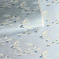 Japanese chiyogami paper with a wave pattern in pale blue, gold and silver.