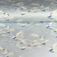 Japanese chiyogami paper with a wave pattern in pale blue, gold and silver.