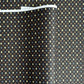 Japanese silkscreen chiyogami paper with a pattern of small repeat motifs in red, blue, lemon and gold on a black background