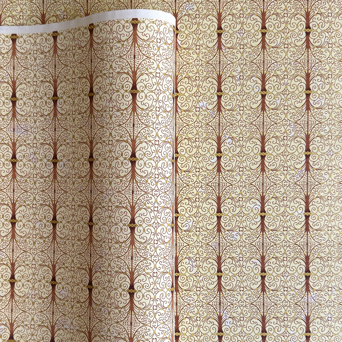 Japanese silkscreen chiyogami paper with a intricate filigree trellis design in brown with gold accent