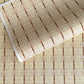 Japanese silkscreen chiyogami paper with a intricate filigree trellis design in brown with gold accent