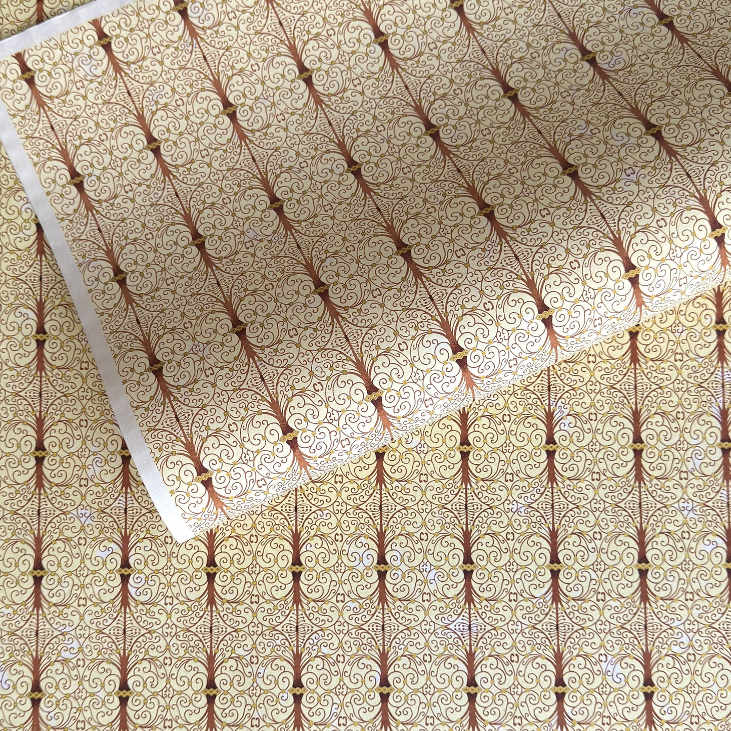 Japanese silkscreen chiyogami paper with a intricate filigree trellis design in brown with gold accent
