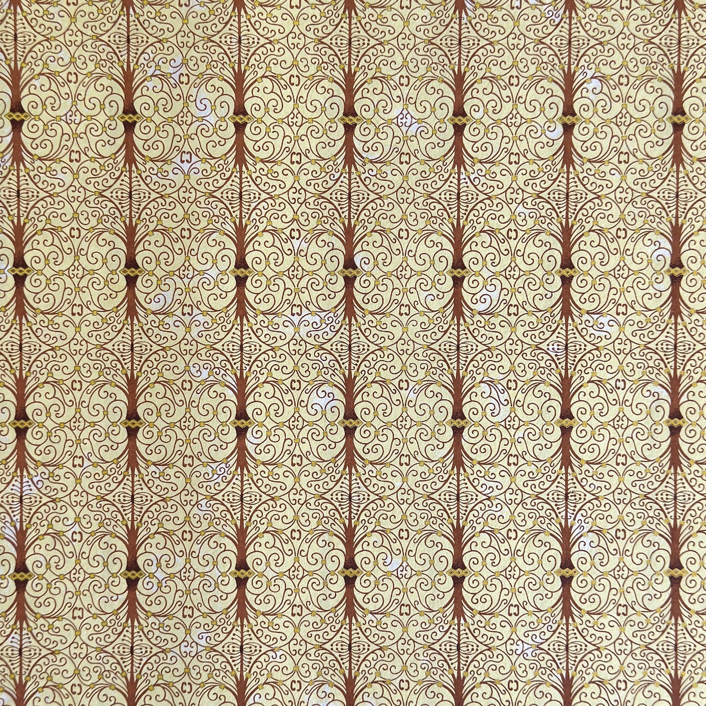Japanese silkscreen chiyogami paper with a intricate filigree trellis design in brown with gold accent