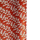 A close-up of a red sheet of Japanese chiyogami paper with an all-over repeating pattern of white cranes and small gold wave-like motifs. 