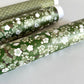 Japanese chiyogami paper with white and pale green blossom flowers on dark green backdrop.