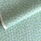 japanese silk-screen paper, chiyogami, with a cherry blossom flower repeat pattern in turquoise and white