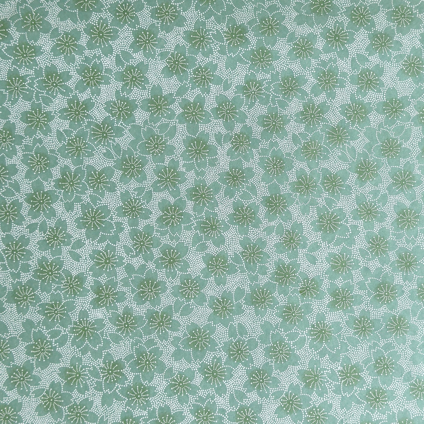 japanese silk-screen paper, chiyogami, with a cherry blossom flower repeat pattern in turquoise and white