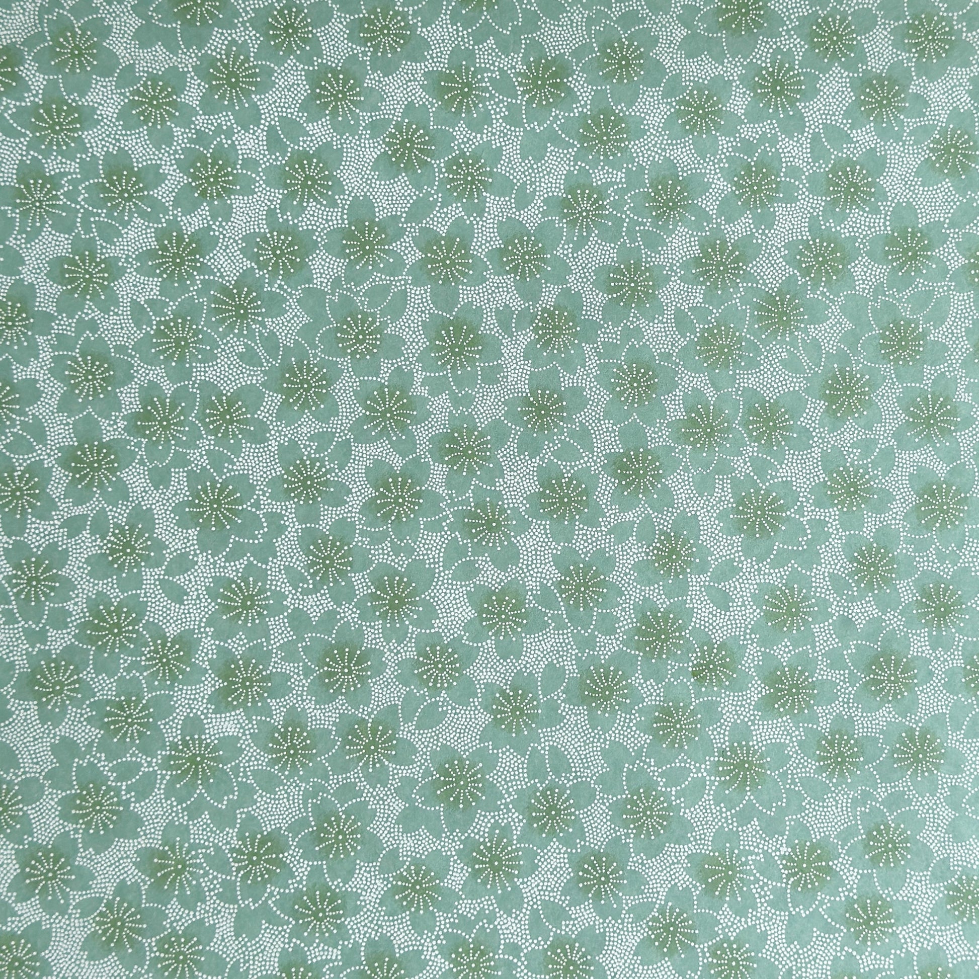 japanese silk-screen paper, chiyogami, with a cherry blossom flower repeat pattern in turquoise and white