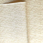 a sheet of Japanese silkscreen printed chiyogami paper with a copper wave design on white ground