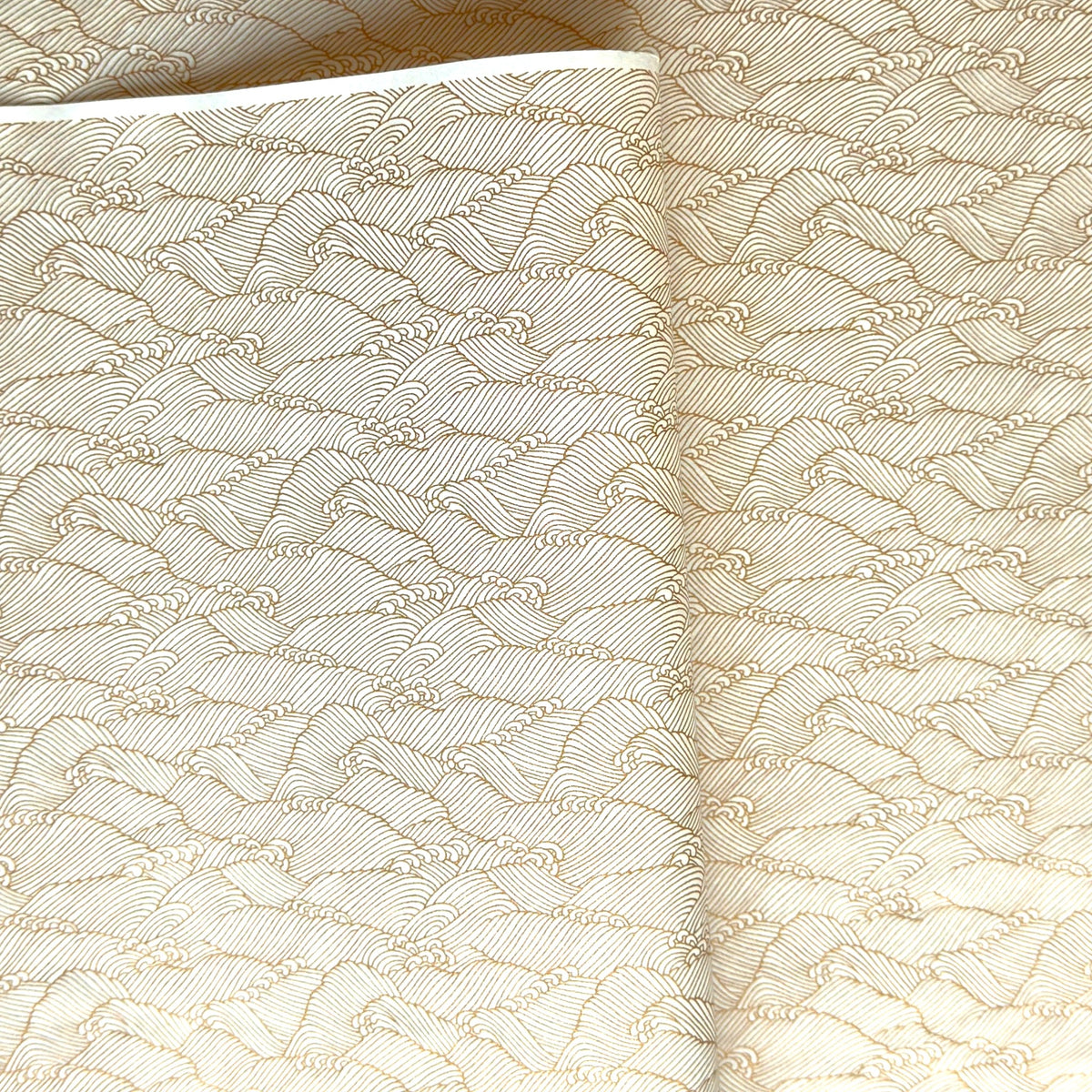 a sheet of Japanese silkscreen printed chiyogami paper with a copper wave design on white ground