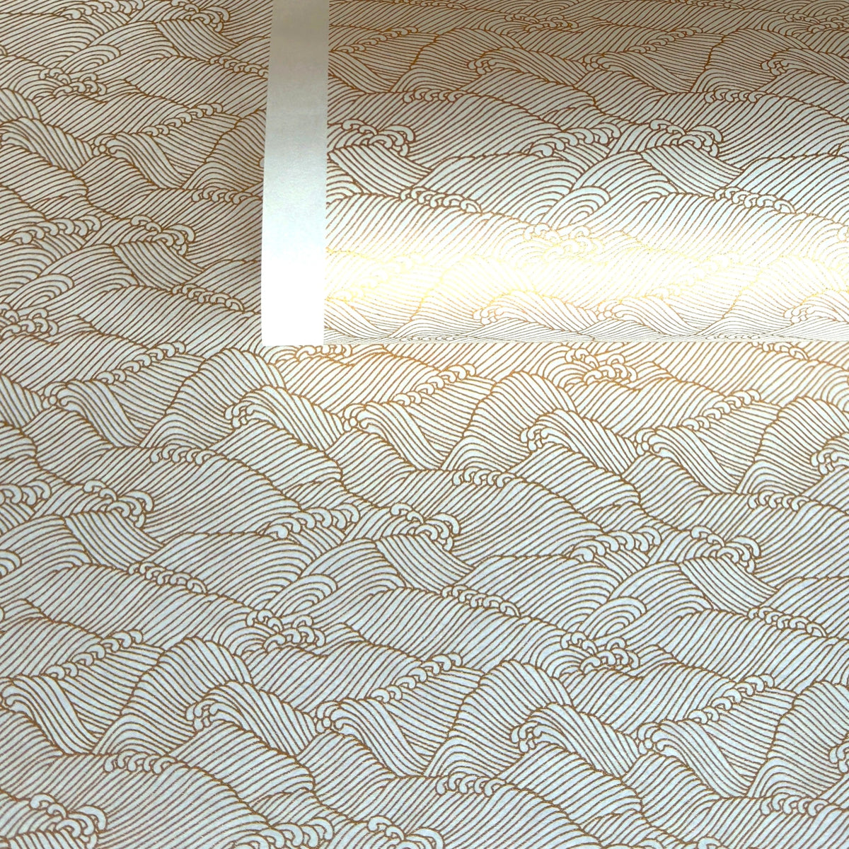 a sheet of Japanese silkscreen printed chiyogami paper with a copper wave design on white ground
