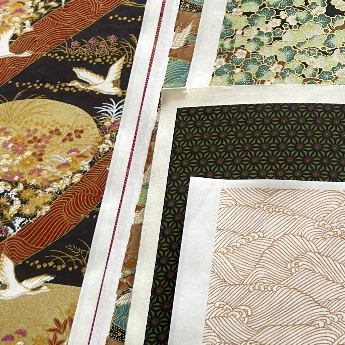 a sheet of Japanese silkscreen printed chiyogami paper with a copper wave design on white ground. Pictured like a mood board layout with other chiyogami designs