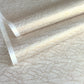 a sheet of Japanese silkscreen printed chiyogami paper with a copper wave design on white ground