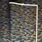 a sheet of Japanese chiyogami paper with gold and silver chevron stripes on black ground