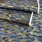 a sheet of Japanese chiyogami paper with gold and silver chevron stripes on black ground