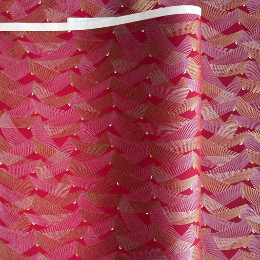 a sheet of Japanese chiyogami paper with a pattern of gold and pink striped chevron lines on fuchsia ground