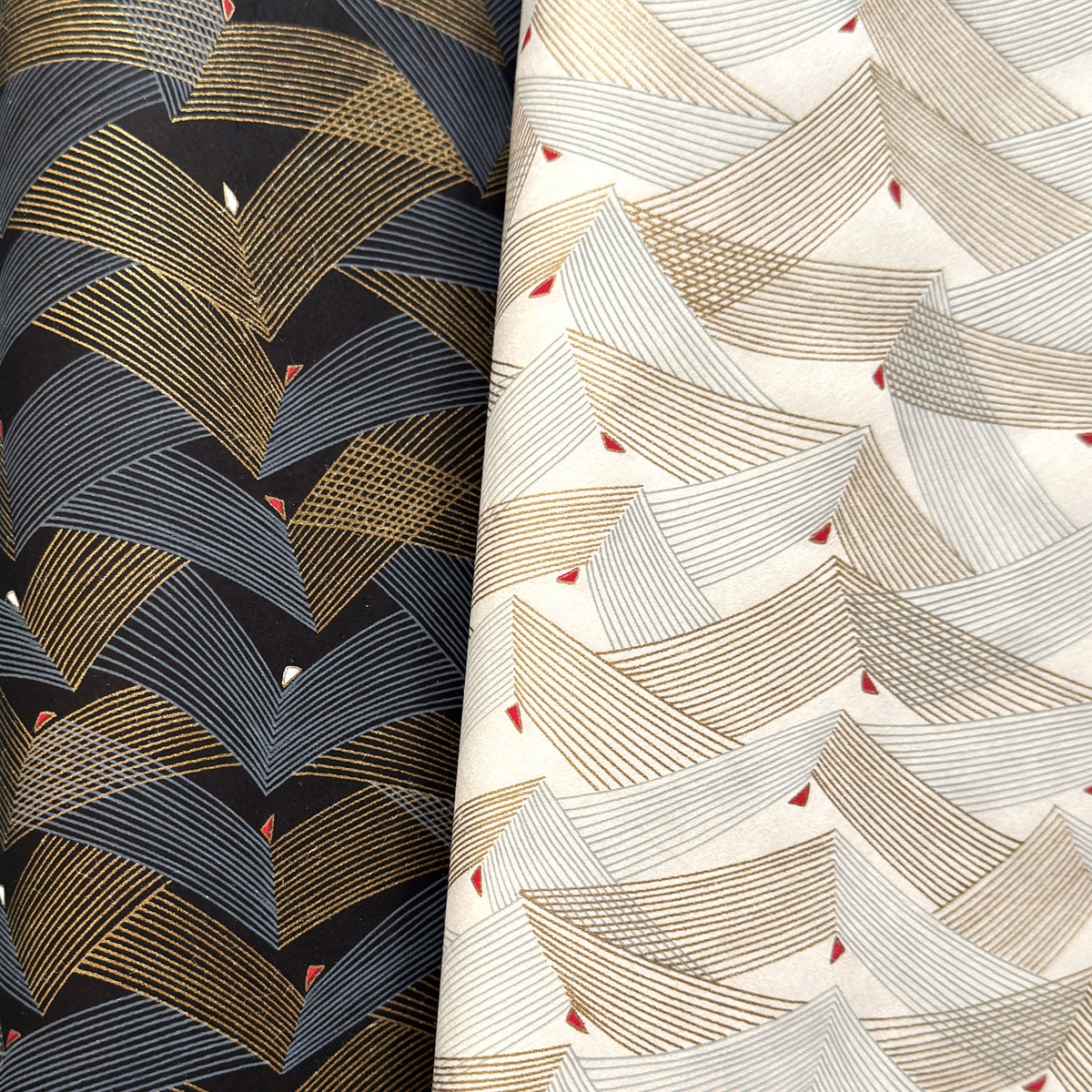 a close of of two sheet of Japanese chiyogami paper with chevron patterns. On the left a version in black with gold and silver and on the right a white version.