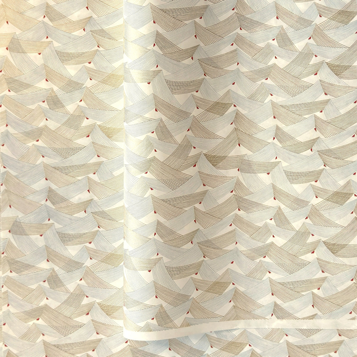 a sheet of Japanese chiyogami paper with gold and silver chevron lines on white paper