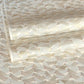 a sheet of Japanese chiyogami paper with gold and silver chevron lines on white paper