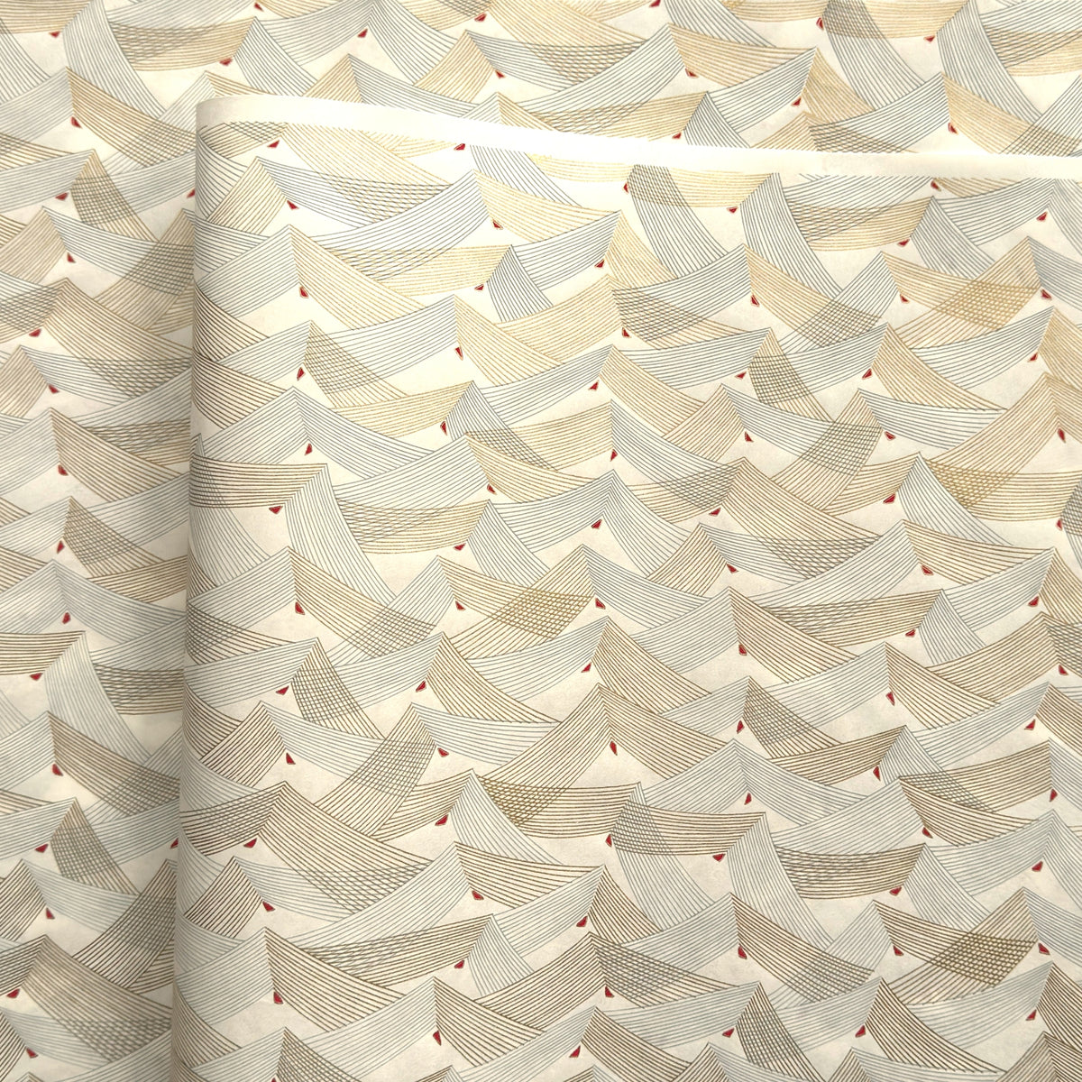 a sheet of Japanese chiyogami paper with gold and silver chevron lines on white paper