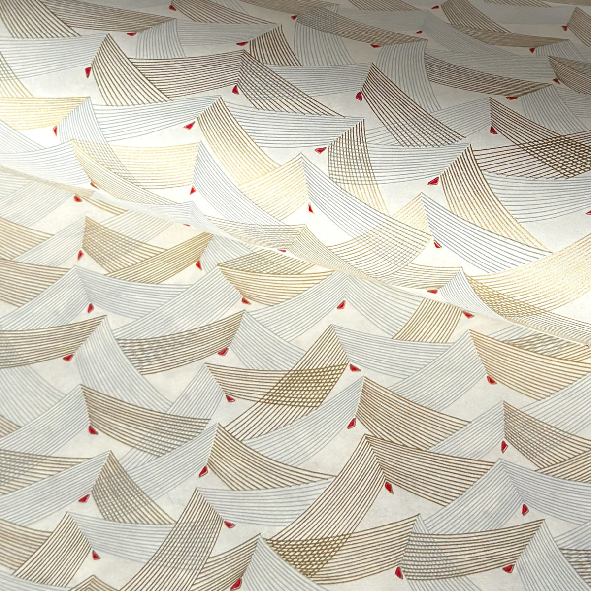 a sheet of Japanese chiyogami paper with gold and silver chevron lines on white paper