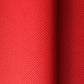 A close-up of a bright red sheet of chiyogami paper with a fine dotted pattern in gold. 