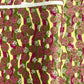 a sheet of Japanese chiyogami yuzen paper with wavy stripes in magenta, green and yellow, overlaid with circles with delicate flowers in the middle and outlined in gold.