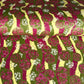 a sheet of Japanese chiyogami yuzen paper with wavy stripes in magenta, green and yellow, overlaid with circles with delicate flowers in the middle and outlined in gold.